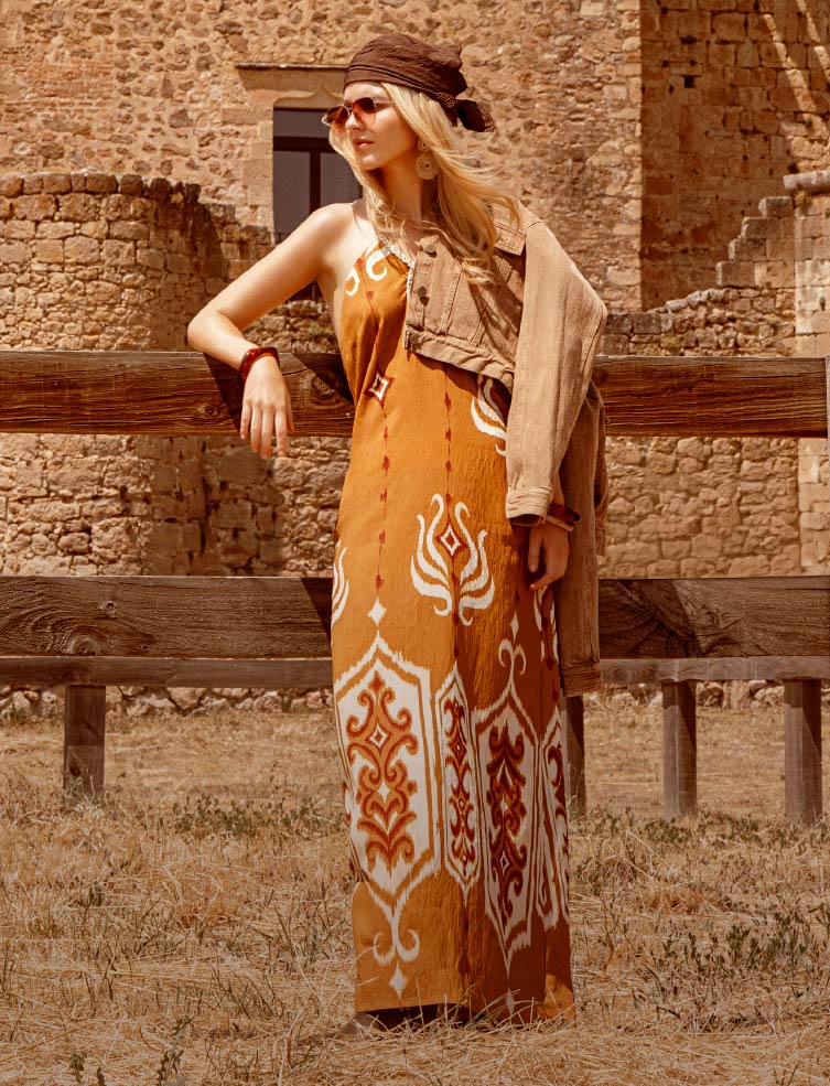 Foto de mujer usando vestido largo de color blanco sobre fondo negro